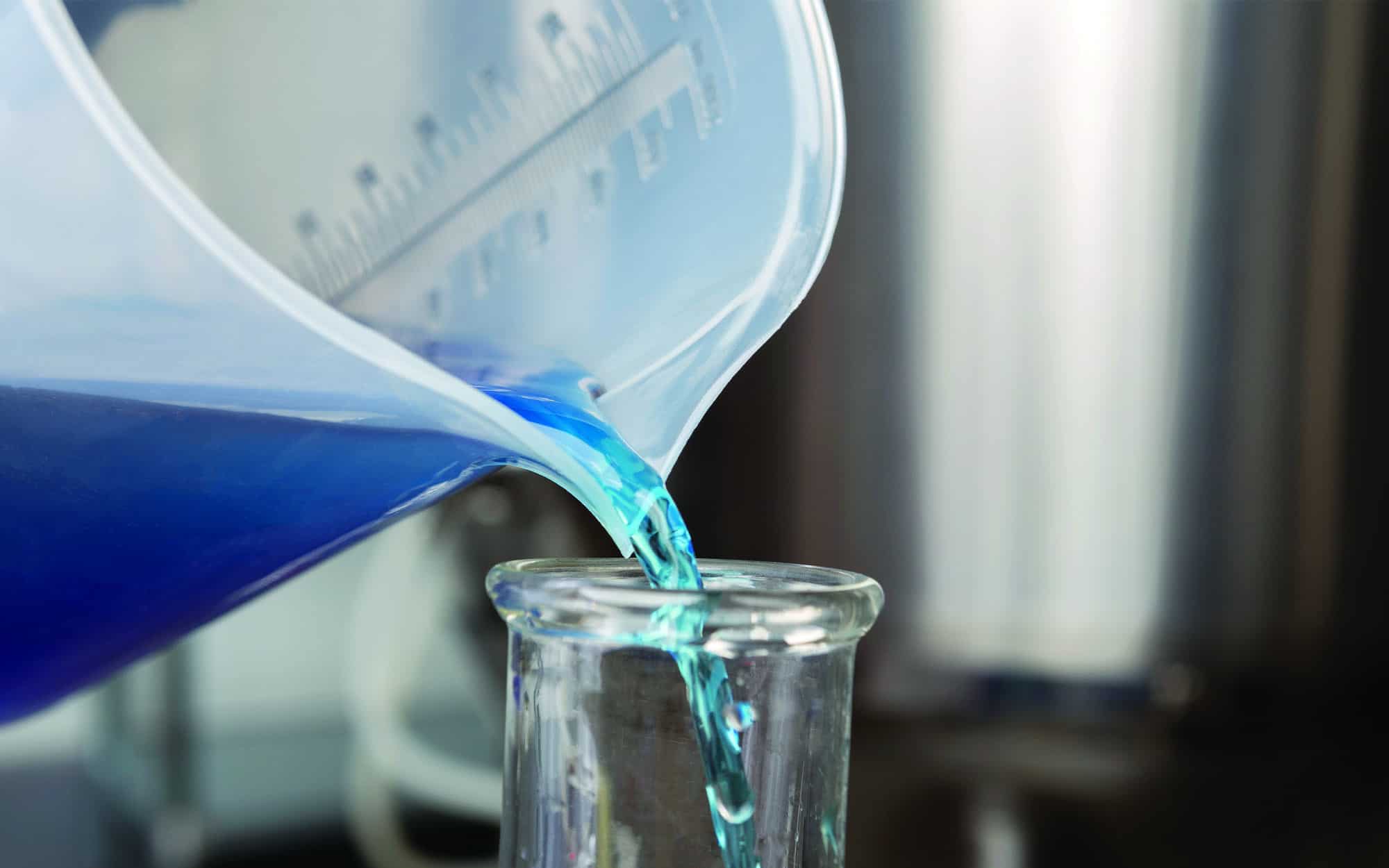 https://axiomproductsusa.com/wp-content/uploads/2021/03/Close-up-of-toxic-blue-lquid-going-into-measuring-cup.jpg